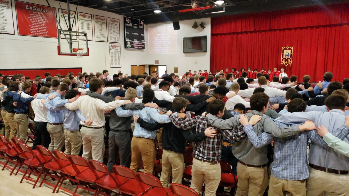 Students arm-in-arm in gym